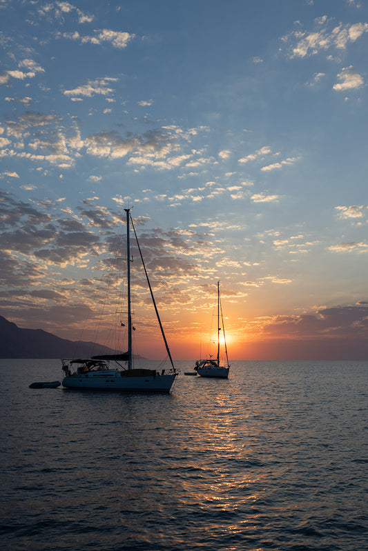 Photograph of two sailboats on a calm sea at sunrise with a white frame. Mediterranean Sailing Photography Art Prints.