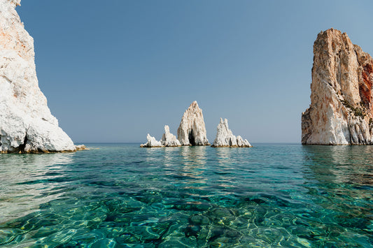 Greek Islands art print schowcasing vibrant blue landscape image of rocks and ocean at Polyaigos Island near Milos. High quality Greece fine art photographic print.