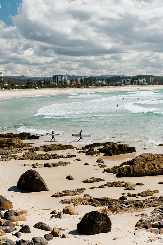 Framed photograph of a beach scene with people walking along the shore. Relive your summer memories with Australia Coastal Fine Art Photography Prints by Brooke Darling Photography. Kirra Beach Surfers Wall Art.