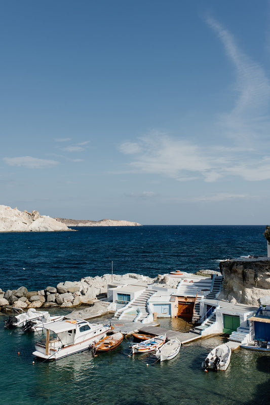 Art photograph of a coastal scene with boats and a clear blue sky. MILOS ISLAND, CYCLADES, GREECE. SHOP Milos Fine Art Photography Prints. Bring summer love and vibes into your home with Milos Framed Wall Art.