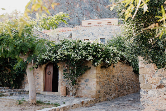 Framed photograph of a stone building with greenery and flowers. Monemvasia Greece Wall Art.