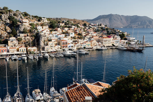 Framed photograph of a coastal town with boats docked in a harbour. SHOP HERE. SYMI, DODECANESE ISLANDS, GREECE | Symi Island Wall Art Prints, custom made to order. Bring Greece art into your home. Symi Island Wall Art.