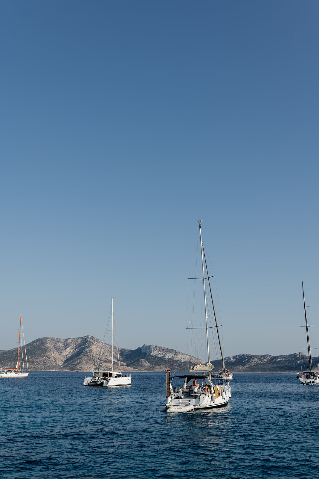 Sailing boats anchored in the Greek Islands available as Sailing fine art wall prints for your home or space.