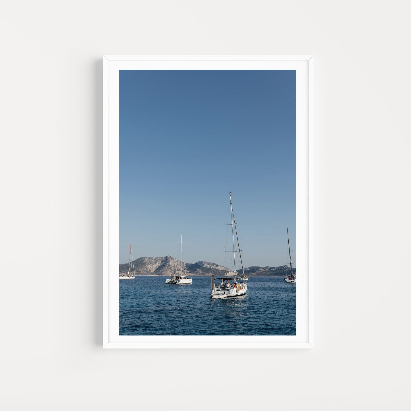 Sailing boats anchored in the Greek Islands available as Sailing fine art wall prints for your home or space.