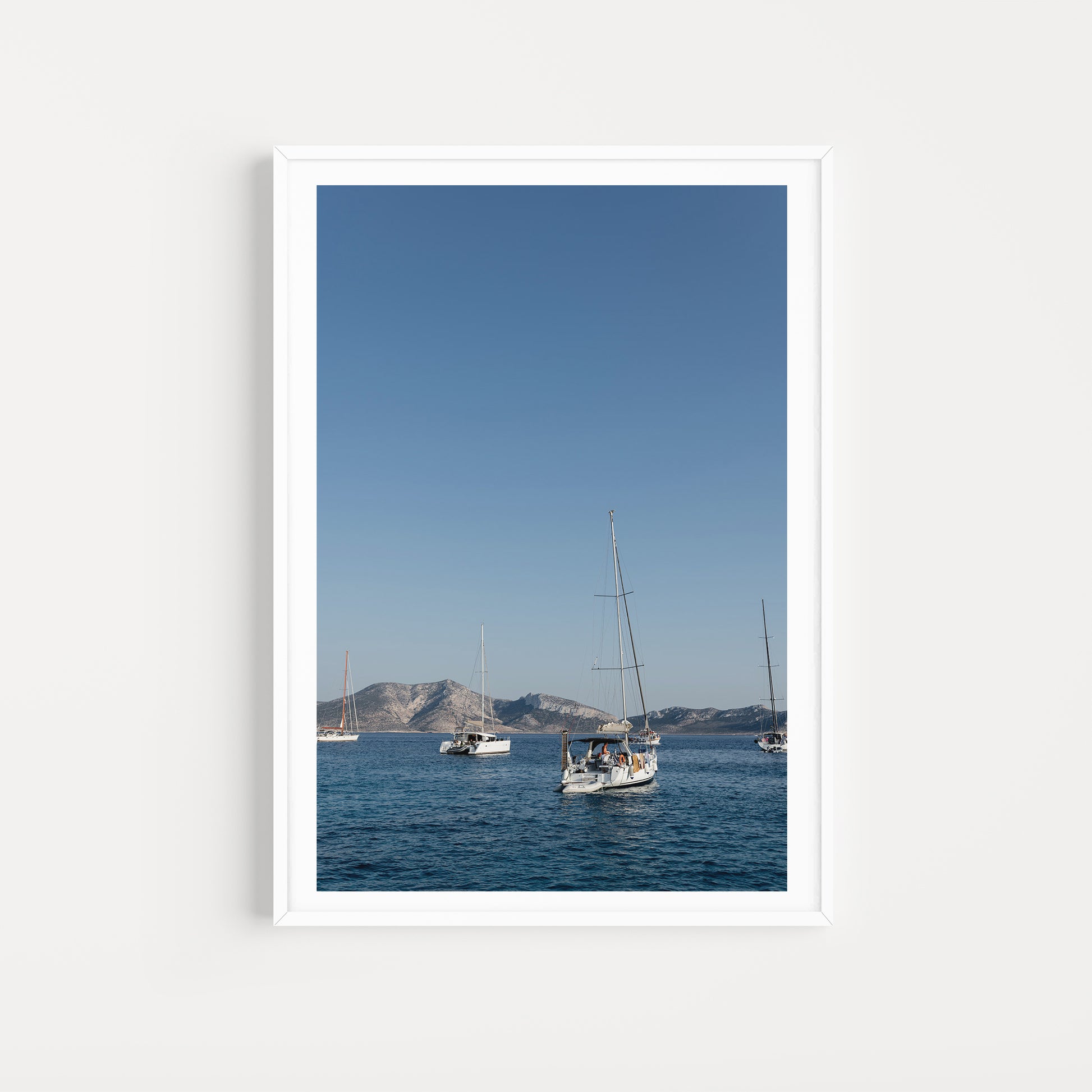 Sailing boats anchored in the Greek Islands available as Sailing fine art wall prints for your home or space.