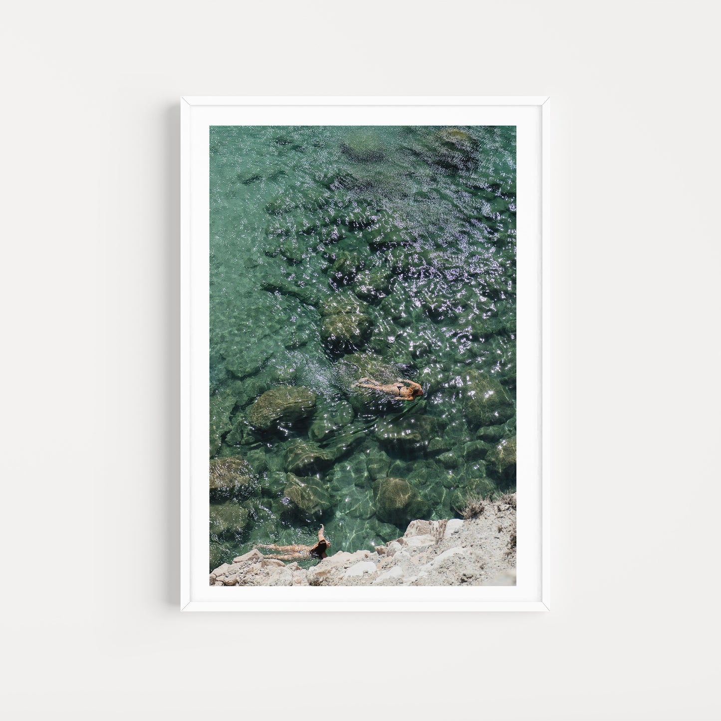 Women swimming in the ocean shot from high above. Bring vacation escapism into your home with Greece Fine Art Photographic Prints by Brooke Darling. Milos Island Mood. Greece Fine Art Prints. 
