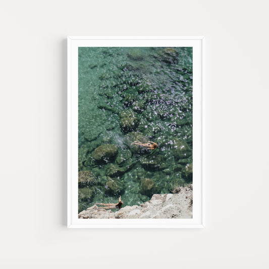 Women swimming in the ocean shot from high above. Bring vacation escapism into your home with Greece Fine Art Photographic Prints by Brooke Darling. Milos Island Mood. Greece Fine Art Prints. 