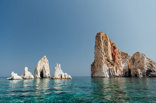 Greek Islands art print schowcasing vibrant blue landscape image of rocks and ocean at Polyaigos Island near Milos. High quality Greece fine art photographic print.