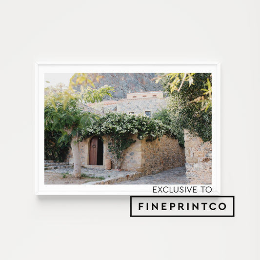 Framed photograph of a stone building with greenery and flowers. Monemvasia Greece Wall Art.