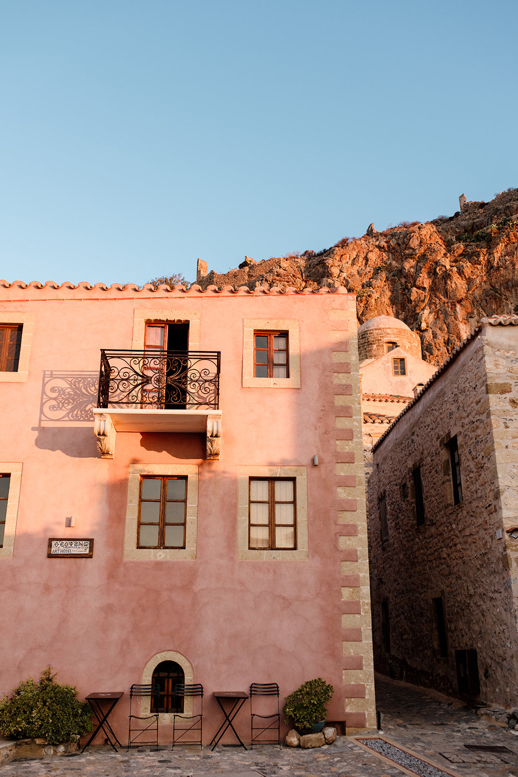Framed photograph of a pink building with a mountain in the background. Browse beautiful Monemvasia Fine Art Prints Fine. Bring the style of vintage Greece architecture into your home with Monemvasia Wall Art Prints. 