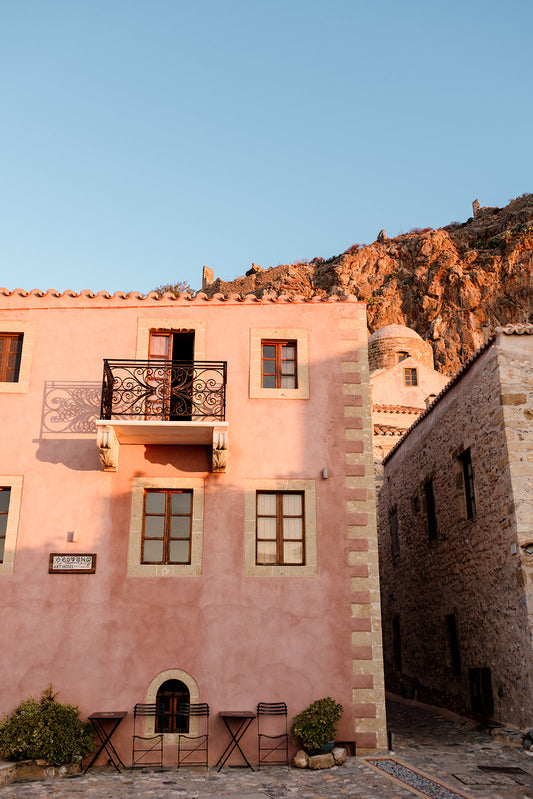 Framed photograph of a pink building with a mountain in the background. Browse beautiful Monemvasia Fine Art Prints Fine. Bring the style of vintage Greece architecture into your home with Monemvasia Wall Art Prints. 