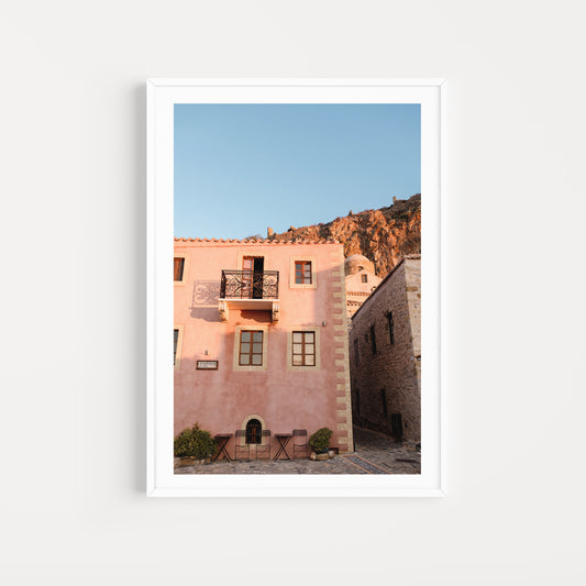 Framed photograph of a pink building with a mountain in the background. Browse beautiful Monemvasia Fine Art Prints Fine. Bring the style of vintage Greece architecture into your home with Monemvasia Wall Art Prints. 