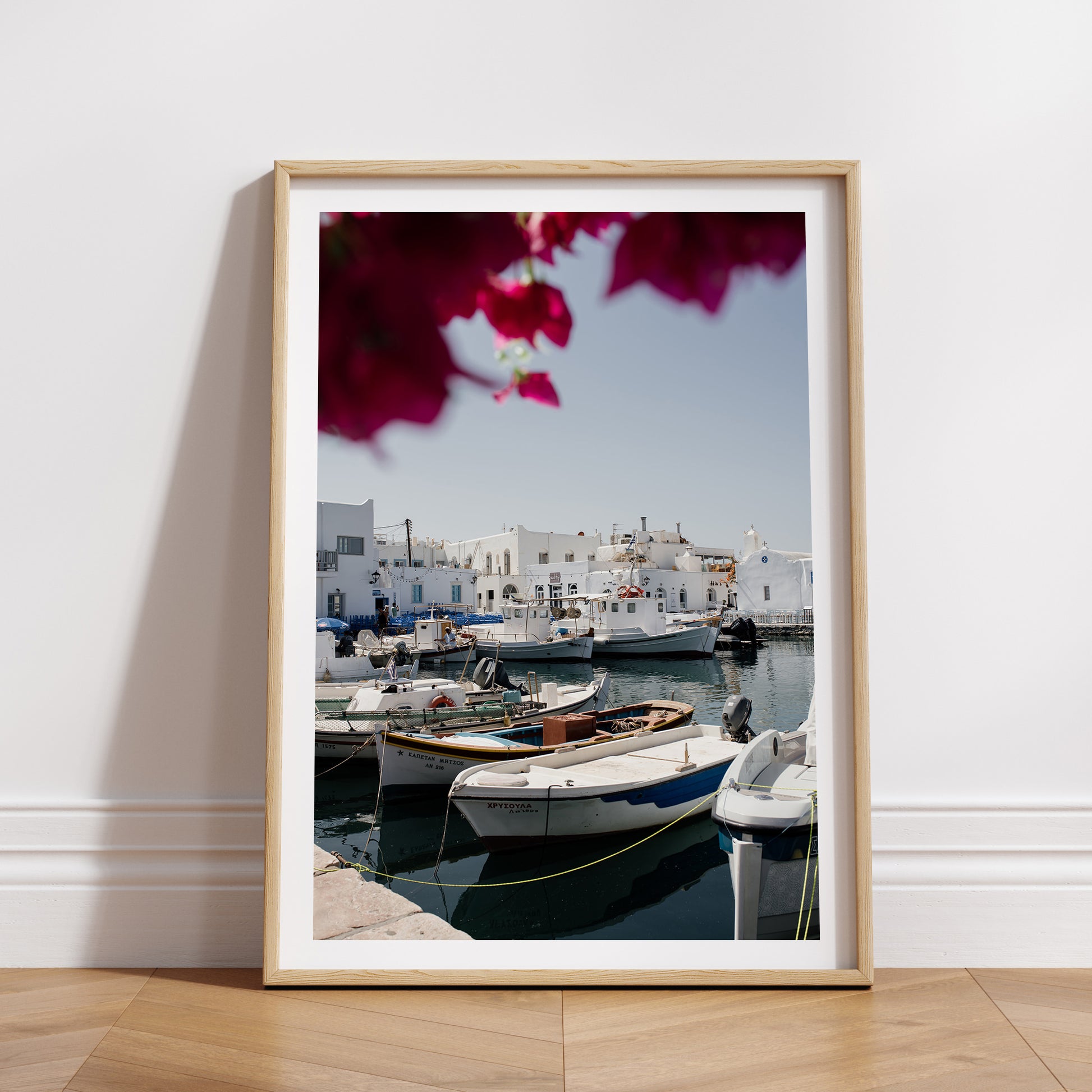 Portrait mock up print of Greek Island fine art print featuring famous Naoussa boat harbour on the island of Paros. 