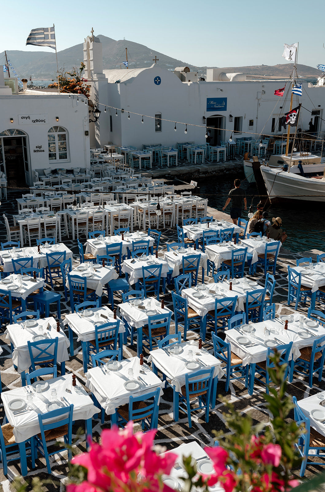 Greece Fine Art Prints of an outdoor taverna on Naoussa boat harbour on the island of Paros. Portrait orientation. By Brooke Darling Photography.