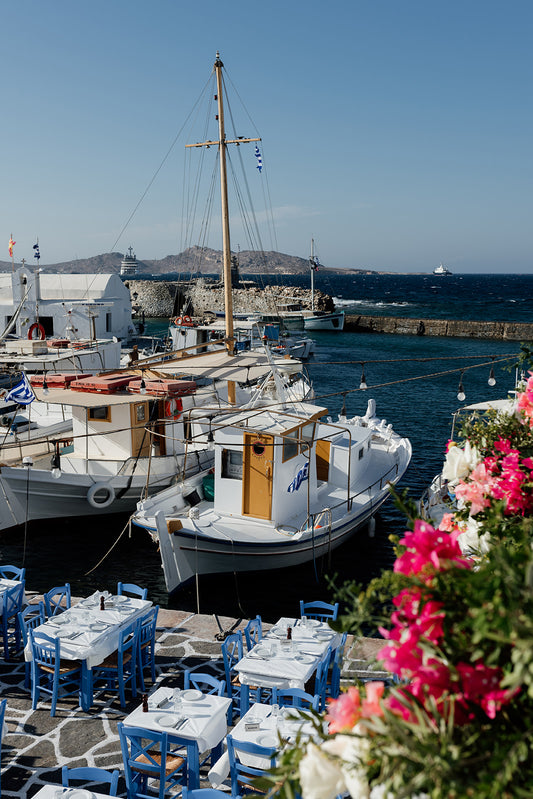 Boat and tables at the famous Naoussa Boat Harbour on Paros Island available at Greece fine art prints for your walls. 